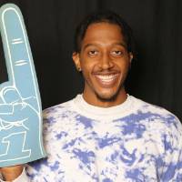 man posing with foam finger